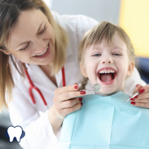 Dentist cleaning smiling childs teeth